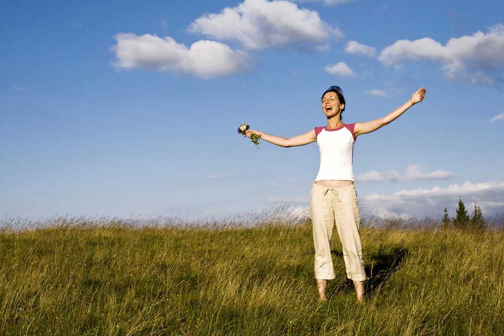 CareAcross-woman-flowers-field